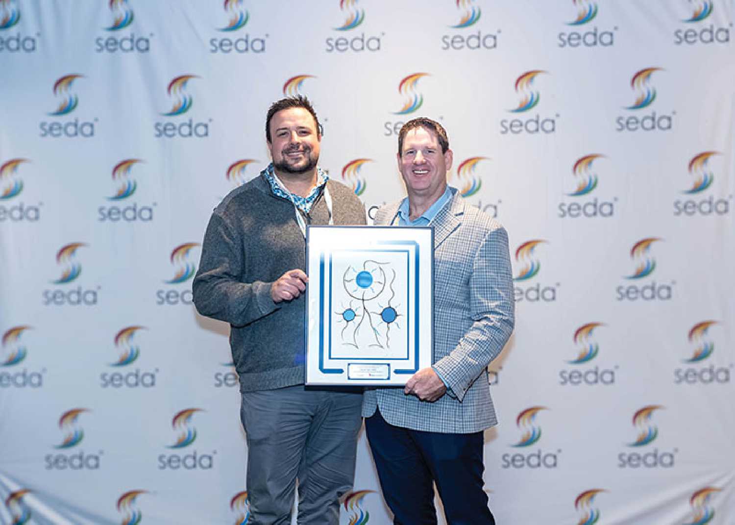 Moosomin Mayor Murray Gray, right, accepting the 2025 Community Project Award on behalf of the RM of Moosomin at the SEDA Summit in Saskatoon on Nov. 4.